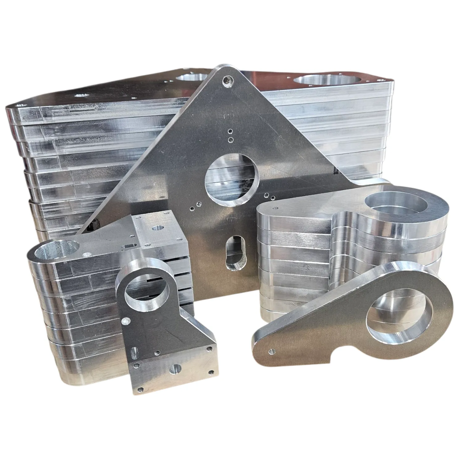 Full set of finished precision parts machined from 16mm marine-grade aluminium plate, arranged for the camera