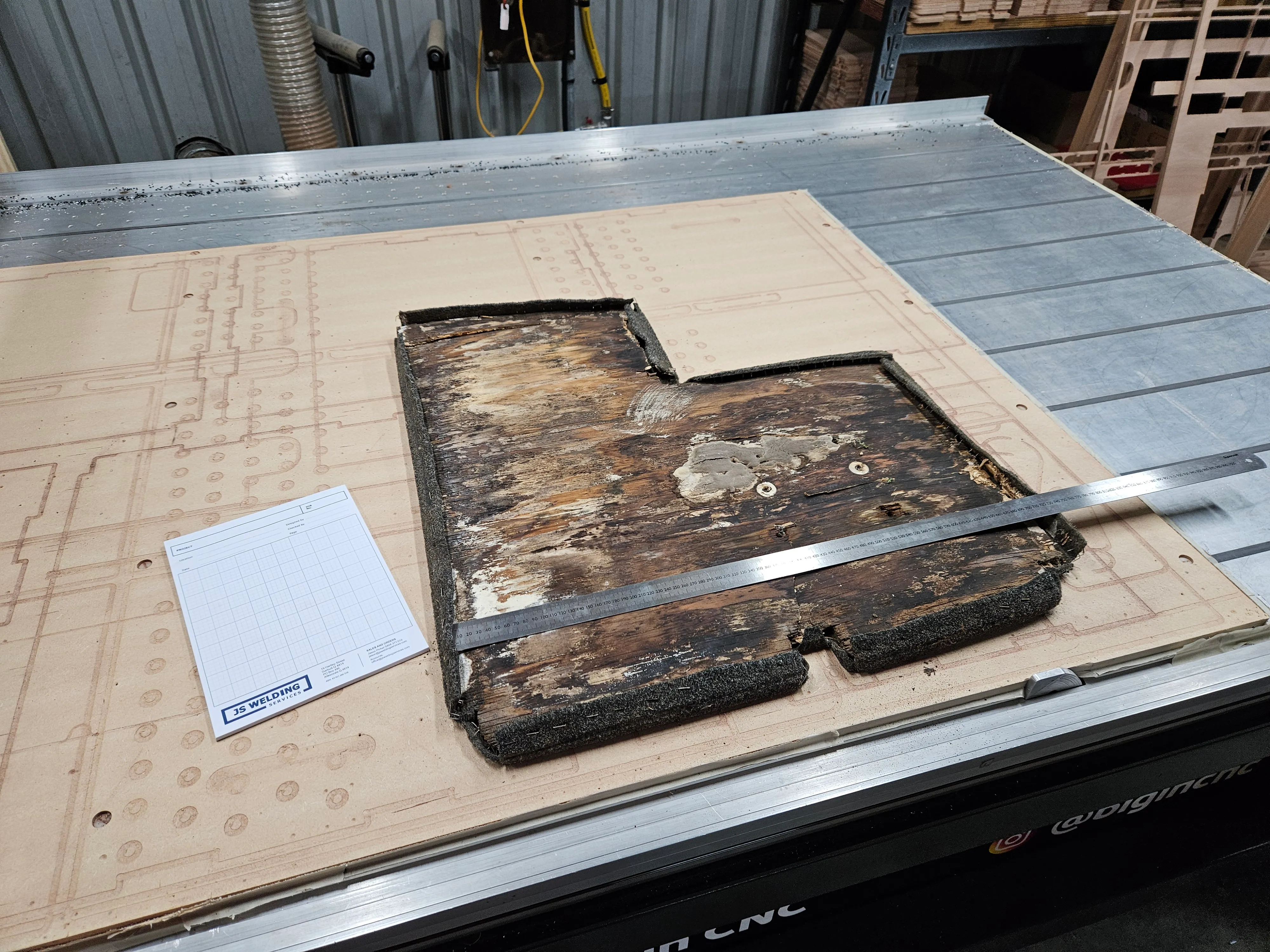 The rotting original boat floor panel on the Multicam bed, ready to be measured